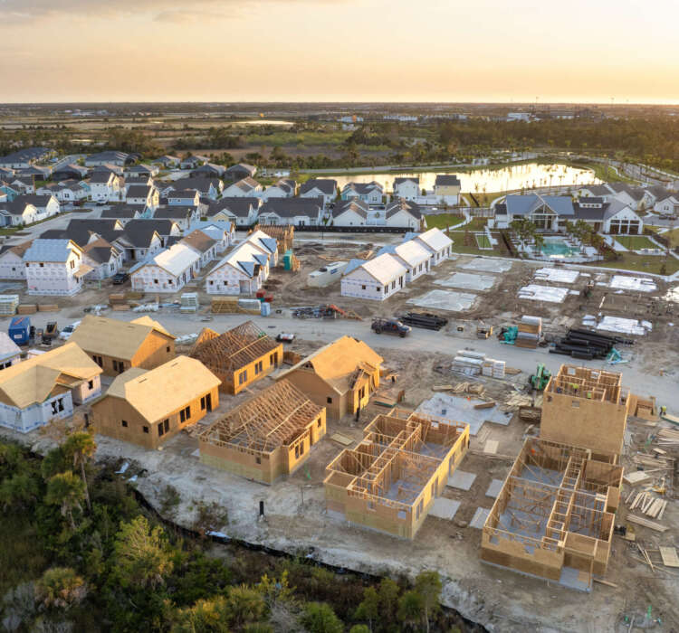 Development of residential housing in the USA. Wooden frames of new cheap American homes under construction.