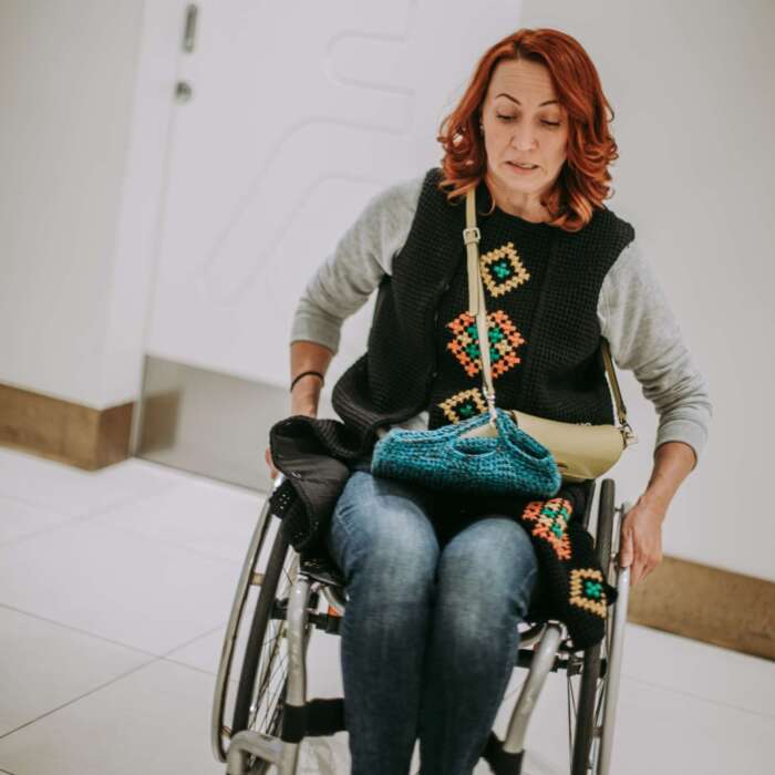 woman-in-a-wheelchair-near-washroom-door-with-a-t-2023-11-27-05-21-56-utc woman-in-a-wheelchair-near-washroom-door-with-a-t-2023-11-27-05-21-56-utc