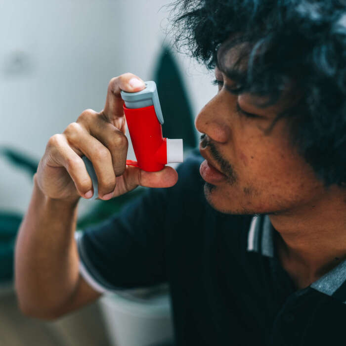 young-man-using-asthma-inhaler-2023-11-29-00-07-59-utc young-man-using-asthma-inhaler-2023-11-29-00-07-59-utc